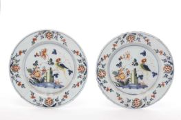 A PAIR OF DELFTWARE CHARGERS LAMBETH, C.1760 each polychrome painted with a parrot seated on a