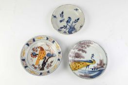 A DELFTWARE 'FARMHOUSE' PLATE BRISTOL, C.1720-40 painted with a peacock in yellow, blue and red,