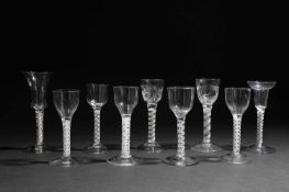 NINE SMALL WINE GLASSES C.1750 AND LATER comprising: one with a bell shaped bowl on an double series