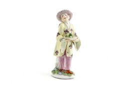 A MEISSEN MODEL OF A CHINESE MAN C.1740-50 modelled by P Reinicke, he stands wearing a yellow jacket