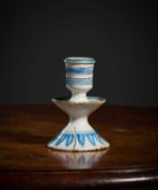 A RARE DELFTWARE SMALL CANDLESTICK LAMBETH, C.1650-80 the urn shaped socket above a dished drip