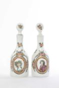A PAIR OF CONTINENTAL MILCHGLASS DECANTERS AND STOPPERS 19TH CENTURY painted with oval portraits
