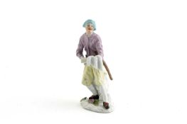 A SMALL MEISSEN FIGURE OF A STREET VENDOR C.1740 possibly a baker, he stands holding a tray and with