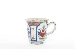 A DELFTWARE COFFEE CUP LONDON, C.1720 of slightly flaring bell form, polychrome painted with