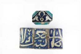 FOUR QAJAR TILES PERSIA, 19TH CENTURY comprising: three with calligraphic script and one with a