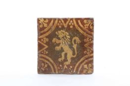 A MEDIEVAL ENCAUSTIC TILE 14TH OR 15TH CENTURY decorated in cream slip with a lion rampant inside