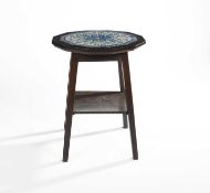 In the manner of Liberty & Co. An oak occasional table with an inset tile top, circa 1900