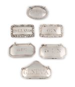 A collection of small antique silver wine labels,