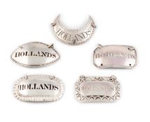 A collection of antique silver 'Hollands' labels,