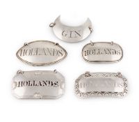 A collection of antique silver wine labels,