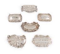 A collection of antique silver wine labels,