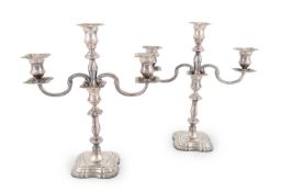 A pair of modern silver candelabras,