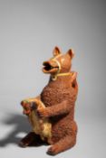 AN EARTHENWARE BEAR JUG AND COVER