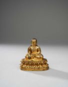 A TIBETAN GILT-BRONZE FIGURE OF A LAMA