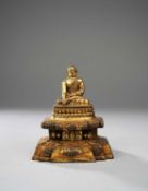 A TIBETAN GILT-BRONZE FIGURE OF A LAMA