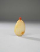 A CHINESE WHITE AND RUSSET JADE PEBBLE SNUFF BOTTLE