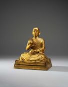 A RARE AND INSCRIBED CHINESE GILT-BRONZE FIGURE OF THE FIFTH PANCHEN LAMA, LOBSANG YESHE (1663-1737)