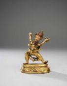 A TIBETAN GILT-BRONZE FIGURE OF DHARMAPALA YAMA