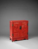 A CHINESE CARVED CINNABAR LACQUER 'BOYS AND SCHOLARS' CABINET