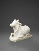 AN INDIAN CARVED MARBLE FIGURE OF A NANDI BULL