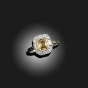 A YELLOW SAPPHIRE AND DIAMOND CLUSTER RING