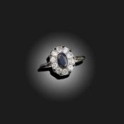 A SAPPHIRE AND DIAMOND CLUSTER RING