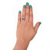 A SAPPHIRE AND DIAMOND CLUSTER RING