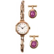 A PAIR OF SYNTHETIC STAR SAPPHIRE CUFFLINKS AND A YELLOW GOLD WRISTWATCH
