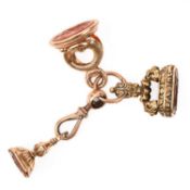 A GROUP OF THREE 19TH CENTURY CARNELIAN-SET FOB SEALS TO A SPLIT RING