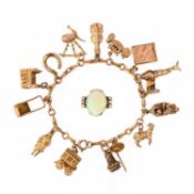 A GOLD CHARM BRACELET AND AN OPAL SET RING