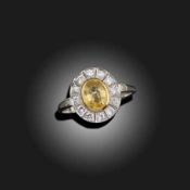 A YELLOW SAPPHIRE AND DIAMOND CLUSTER RING