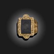 AN ONYX-SET GOLD SIGNET RING
