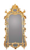A LARGE GILTWOOD AND COMPOSITION WALL MIRROR