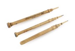 A small collection of three Victorian gold propelling pencils,