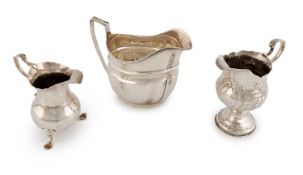 A small collection of three George III silver cream jugs,