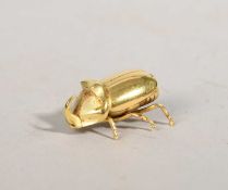 A GOLD MODEL OF A HORN BEETLE