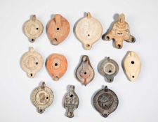 TWELVE POTTERY OIL LAMPS
