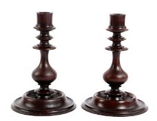 A PAIR OF GEORGE III TREEN WALNUT CANDLESTICKS