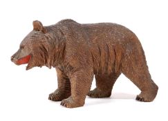 A BLACK FOREST CARVED LINDEN WOOD MODEL OF A BEAR