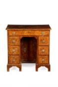 A GEORGE II WALNUT KNEEHOLE DESK