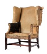 A GEORGE III MAHOGANY WING ARMCHAIR