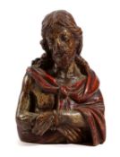 A CARVED FRUITWOOD AND POLYCHROME BUST OF CHRIST