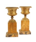 A PAIR OF FRENCH RESTAURATION ORMOLU AND SIENA MARBLE URNS