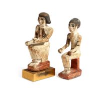 TWO EGYPTIAN STYLE CARVED AND POLYCHROME WOOD SEATED FIGURES