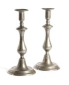 A PAIR OF TALL GEORGE III PEWTER CANDLESTICKS