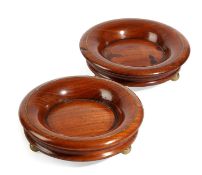 A PAIR OF TURNED MAHOGANY WINE BOTTLE TABLE COASTERS