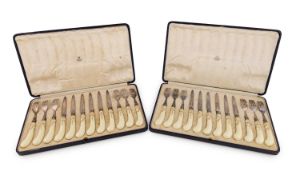 A set of twelve Asprey electroplated and Royal Worcester handled fruit knives and forks,