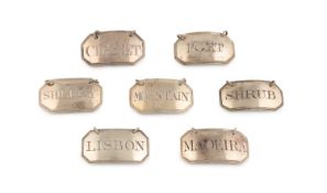 A collection of seven George III silver wine labels,