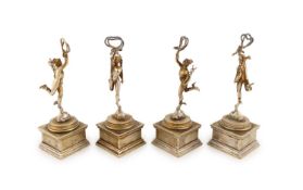 A set of four metalware menu card holders modelled as the Greek God Hermes,