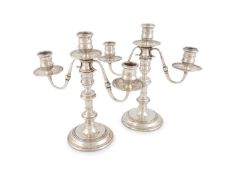 A pair of modern silver candelabra,